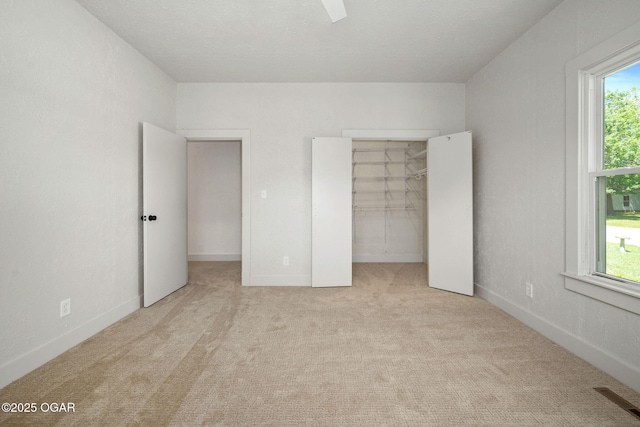 2716 E 14th St, Joplin, MO 64801 - unfurnished bedroom featuring carpet flooring, a spacious closet, and a closet