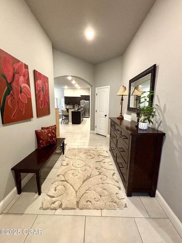 2005 Eagle Dr, Neosho, MO 64850 - hall featuring arched walkways, light tile patterned floors, and baseboards