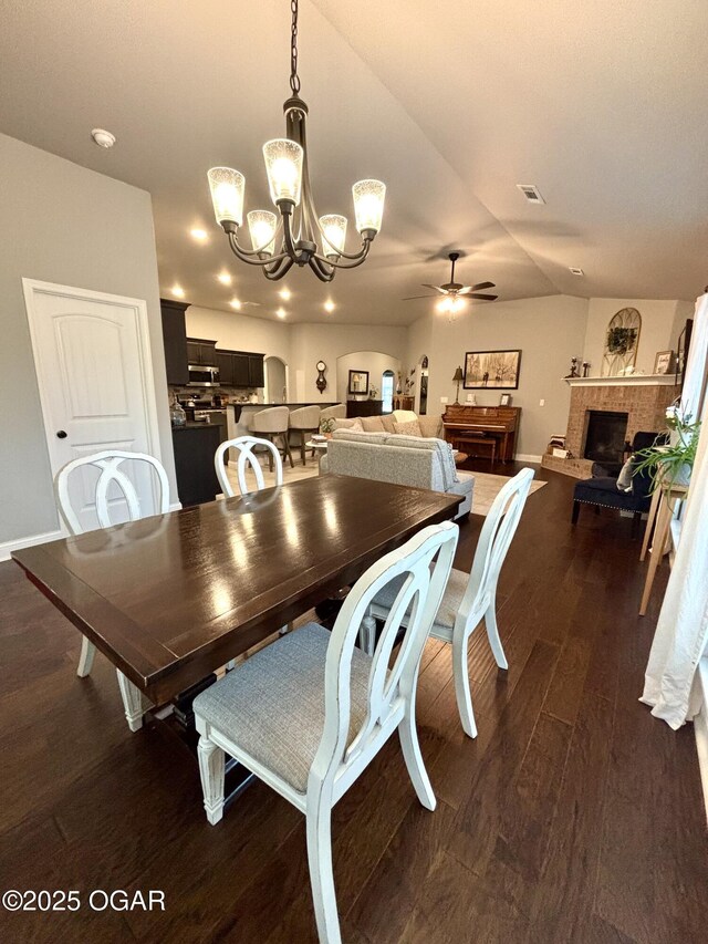 2005 Eagle Dr, Neosho, MO 64850 - dining room featuring a chandelier, a ceiling fan, dark wood finished floors, a fireplace with raised hearth, and baseboards