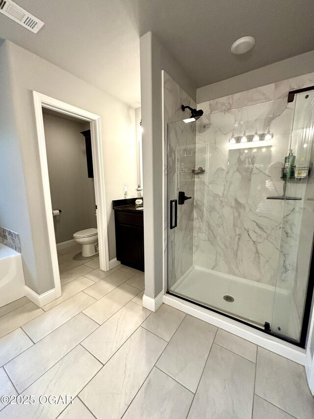 2005 Eagle Dr, Neosho, MO 64850 - bathroom with a marble finish shower, toilet, vanity, marble look tile flooring, and baseboards