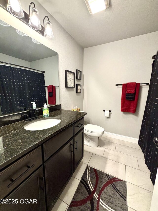 2005 Eagle Dr, Neosho, MO 64850 - bathroom featuring vanity, toilet, tile patterned floors, and baseboards