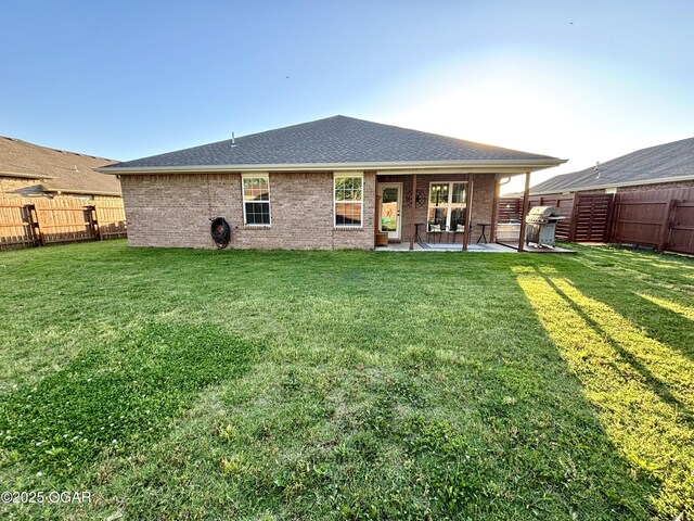 2005 Eagle Dr, Neosho, MO 64850 - rear view of house featuring a patio, brick siding, and roof with shingles