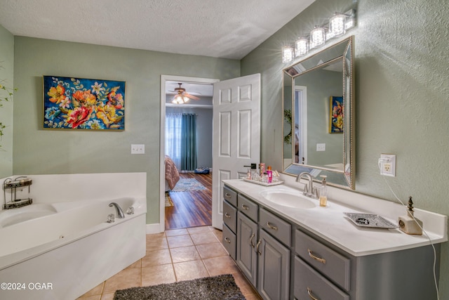 2228 Possum Trot Rd, Billings, MO 65610 - ensuite bathroom featuring vanity, a garden tub, tile patterned flooring, a textured ceiling, and a textured wall
