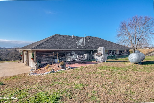 2228 Possum Trot Rd, Billings, MO 65610 - rear view of property featuring a yard, driveway, a patio area, a shingled roof, and an attached garage