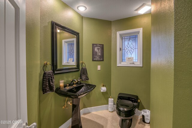 4 Emerald Dr, Joplin, MO 64804 - bathroom featuring tile patterned floors, a textured wall, toilet, and baseboards