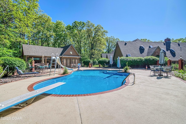 4 Emerald Dr, Joplin, MO 64804 - view of swimming pool featuring a diving board, a water slide, a patio, and an outdoor structure