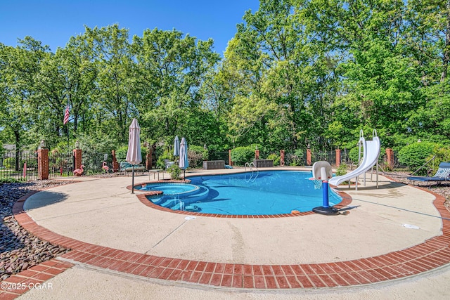 4 Emerald Dr, Joplin, MO 64804 - view of pool with a water slide, a pool with connected hot tub, a patio, and view of scattered trees
