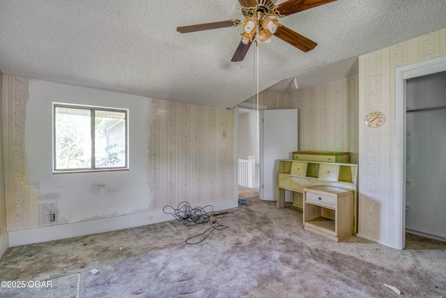 219 N Moffet Ave, Joplin, MO 64801 - unfurnished bedroom with a textured ceiling, carpet flooring, wallpapered walls, and ceiling fan