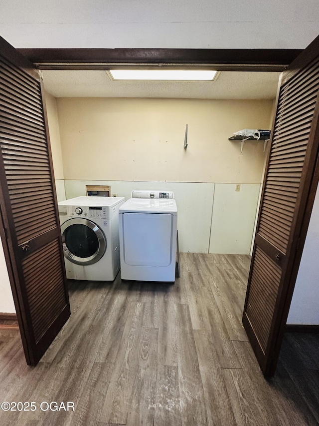 1926 S Main St, Carthage, MO 64836 - laundry area with wood finished floors and washing machine and dryer