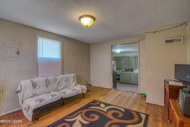 2201 S Main St, Galena, KS 66739 - living room featuring hardwood / wood-style flooring and a textured ceiling