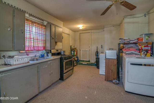 2201 S Main St, Galena, KS 66739 - kitchen featuring stainless steel range with gas cooktop, washer / dryer, a ceiling fan, a sink, and light colored carpet