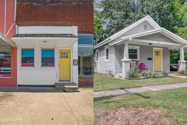 204W9TH & Ave, Baxter Springs, KS 66713 - view of front of house with a front yard, brick siding, entry steps, and a porch