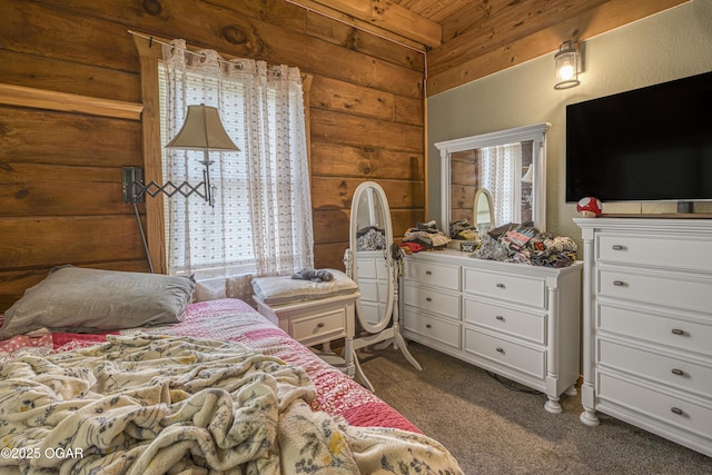 3219 Hughes Ave, Parsons, KS 67357 - bedroom with dark carpet, wood ceiling, and wooden walls