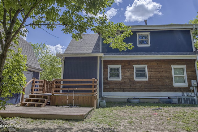 3219 Hughes Ave, Parsons, KS 67357 - back of property featuring a wooden deck, roof with shingles, and a garage