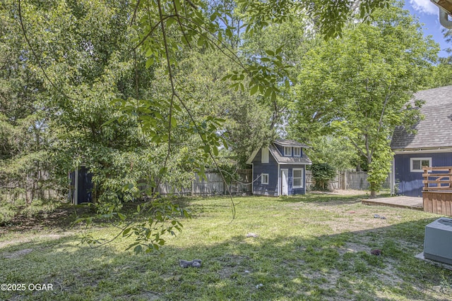 3219 Hughes Ave, Parsons, KS 67357 - view of yard with a deck and an outbuilding