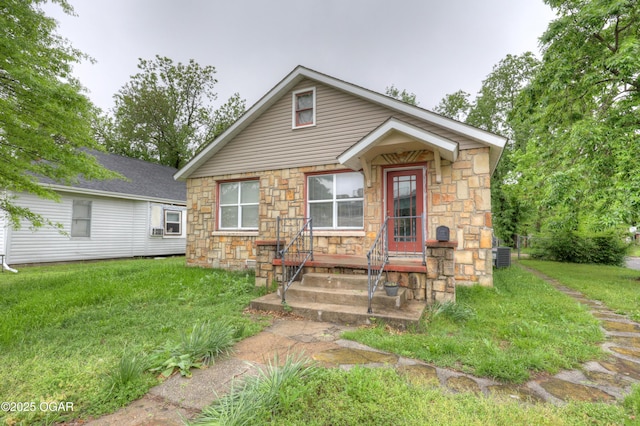 602 S Highland Ave, Joplin, MO 64801 - bungalow-style house featuring stone siding, a front yard, and central AC unit
