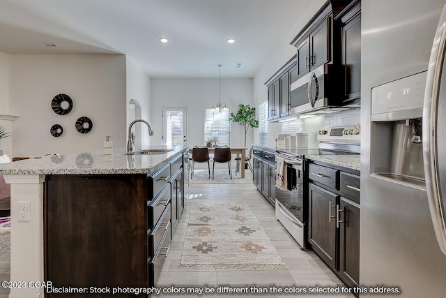 1702 Sedge St, Joplin, MO 64801 - kitchen with appliances with stainless steel finishes, a sink, a center island with sink, recessed lighting, and light stone countertops