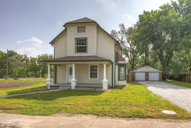 109 N Main St, Alba, MO 64830 - view of front of property with covered porch, an outdoor structure, a detached garage, and a front lawn