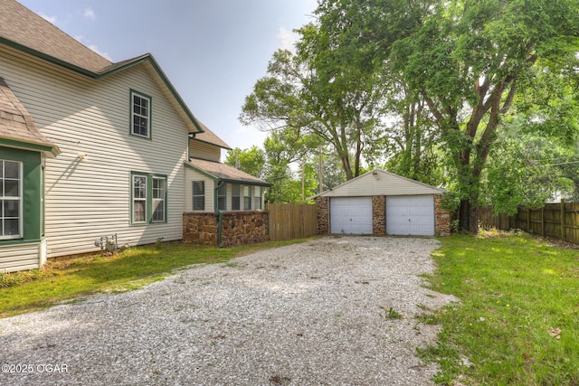 109 N Main St, Alba, MO 64830 - view of side of home featuring a garage, an outbuilding, and roof with shingles