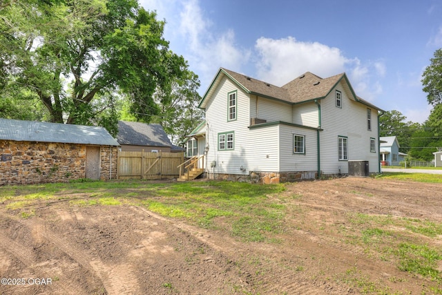 109 N Main St, Alba, MO 64830 - rear view of house with central AC unit and entry steps