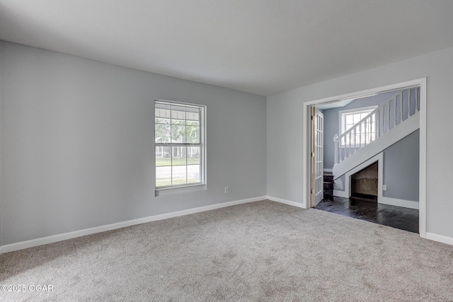 109 N Main St, Alba, MO 64830 - unfurnished room featuring dark carpet, baseboards, and stairway