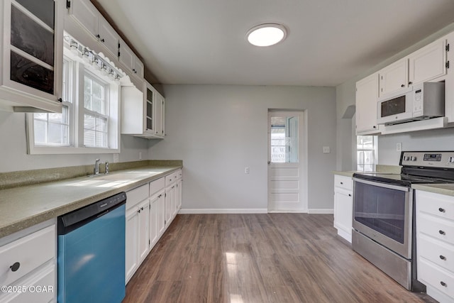 109 N Main St, Alba, MO 64830 - kitchen with stainless steel electric range oven, dishwasher, white microwave, a sink, and dark wood finished floors