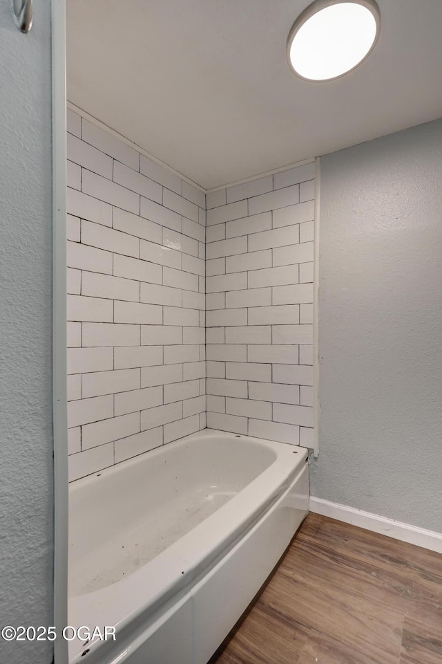 109 N Main St, Alba, MO 64830 - full bath featuring wood finished floors, a tub, and baseboards