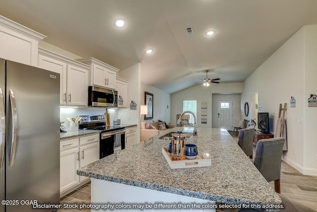 1619 Sedge St, Joplin, MO 64801 - kitchen featuring appliances with stainless steel finishes, a sink, open floor plan, white cabinets, and ceiling fan