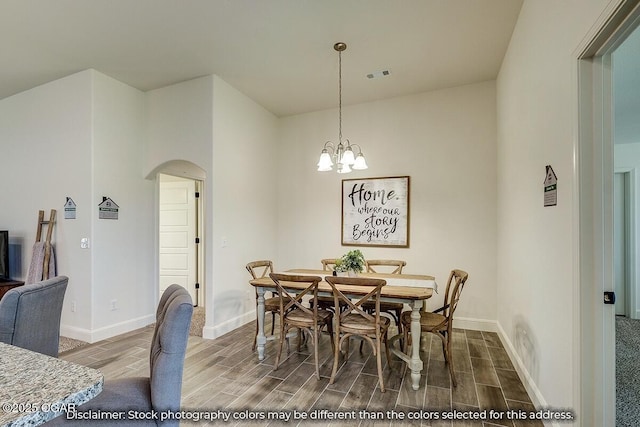 1619 Sedge St, Joplin, MO 64801 - dining room with arched walkways, wood finish floors, and baseboards
