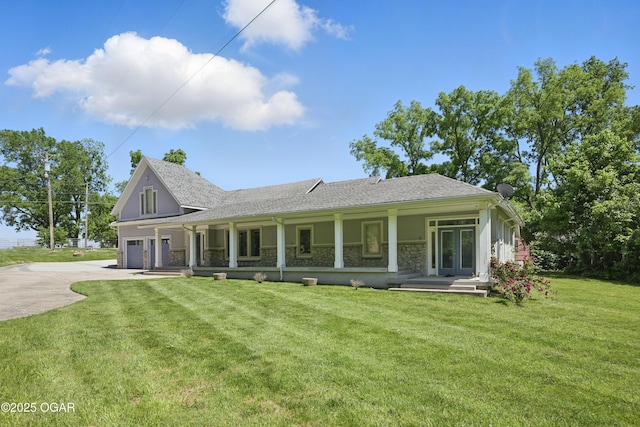 5594 Riverside Dr, Joplin, MO 64804 - view of front facade featuring concrete driveway, covered porch, stone siding, and a front lawn