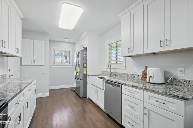 5594 Riverside Dr, Joplin, MO 64804 - kitchen with appliances with stainless steel finishes, baseboards, dark wood-type flooring, and plenty of natural light