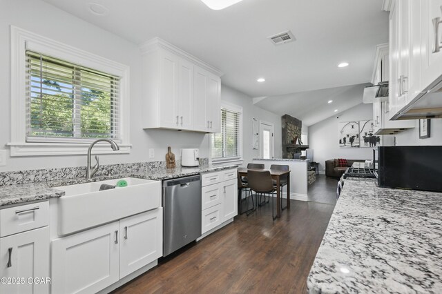 5594 Riverside Dr, Joplin, MO 64804 - kitchen featuring appliances with stainless steel finishes, a sink, dark wood-style flooring, white cabinetry, and light stone counters