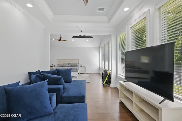 5594 Riverside Dr, Joplin, MO 64804 - living room featuring plenty of natural light, dark wood-type flooring, crown molding, a raised ceiling, and baseboards