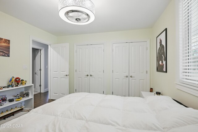 5594 Riverside Dr, Joplin, MO 64804 - bedroom featuring multiple closets and dark wood-style floors