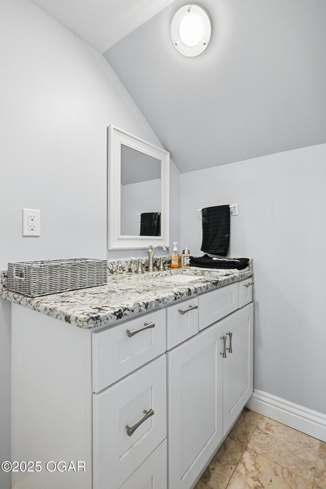 5594 Riverside Dr, Joplin, MO 64804 - bathroom featuring vaulted ceiling, marble finish flooring, vanity, and baseboards