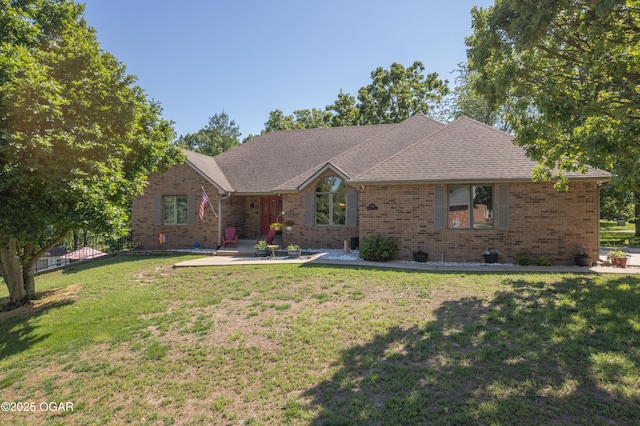 2402 Melissa Ln, Joplin, MO 64804 - ranch-style house with a patio area, brick siding, a front lawn, and a shingled roof