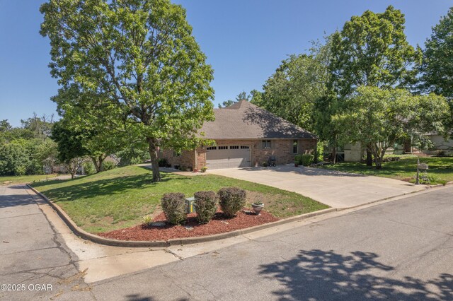 2402 Melissa Ln, Joplin, MO 64804 - view of front of home with driveway, a front yard, a garage, and brick siding