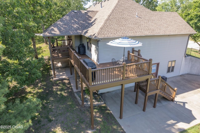 2402 Melissa Ln, Joplin, MO 64804 - rear view of house featuring a shingled roof, a wooden deck, stairway, and a patio area