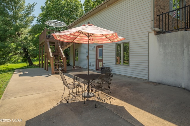 2402 Melissa Ln, Joplin, MO 64804 - view of patio with stairway, outdoor dining area, and a wooden deck