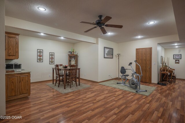 2402 Melissa Ln, Joplin, MO 64804 - exercise area with dark wood-style floors, a ceiling fan, a sink, baseboards, and recessed lighting