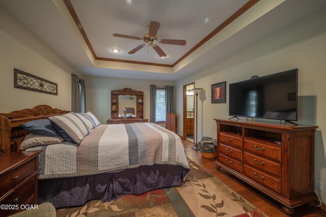 2402 Melissa Ln, Joplin, MO 64804 - bedroom featuring wood finished floors, crown molding, a raised ceiling, ceiling fan, and connected bathroom