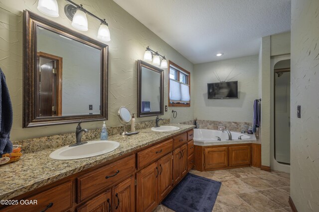 2402 Melissa Ln, Joplin, MO 64804 - bathroom with a garden tub, double vanity, a textured ceiling, a stall shower, and a textured wall