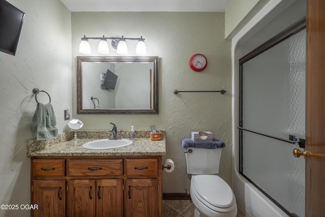 2402 Melissa Ln, Joplin, MO 64804 - full bathroom featuring vanity, toilet, shower / bath combination with glass door, tile patterned flooring, and baseboards
