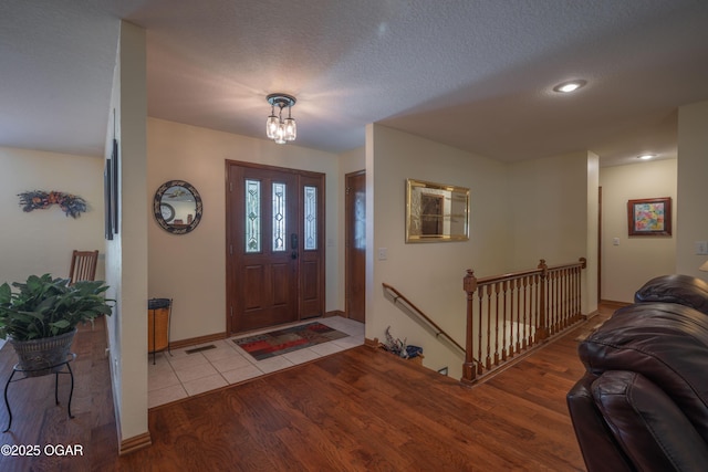 2402 Melissa Ln, Joplin, MO 64804 - entrance foyer with wood finished floors, a chandelier, recessed lighting, baseboards, and a textured ceiling