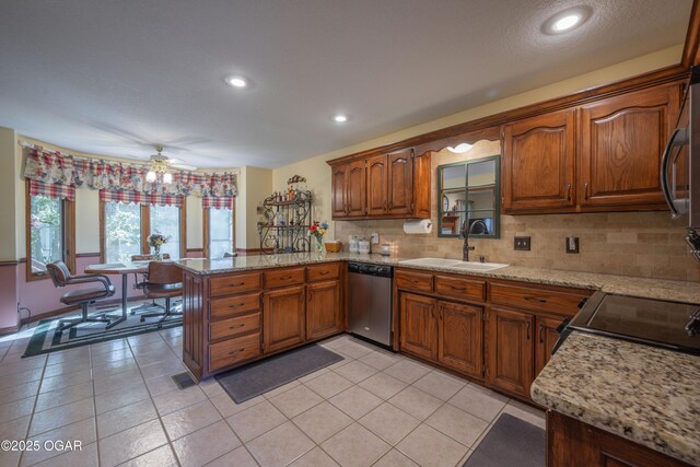 2402 Melissa Ln, Joplin, MO 64804 - kitchen with stainless steel dishwasher, a peninsula, a sink, brown cabinetry, and ceiling fan