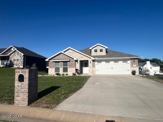 305 Ashmore Dr, Carl Junction, MO 64834 - view of front of house with driveway, a garage, and a front lawn