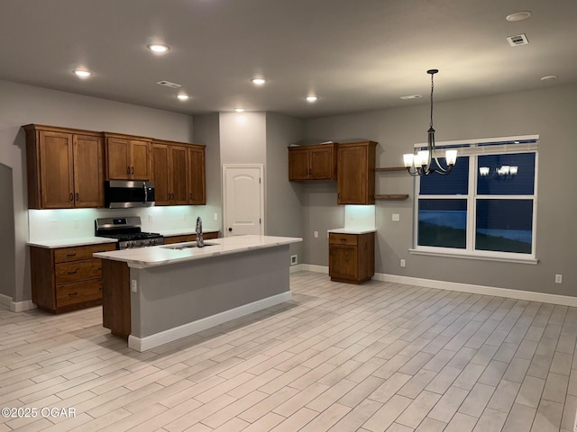 305 Ashmore Dr, Carl Junction, MO 64834 - kitchen with appliances with stainless steel finishes, a sink, light countertops, a chandelier, and baseboards