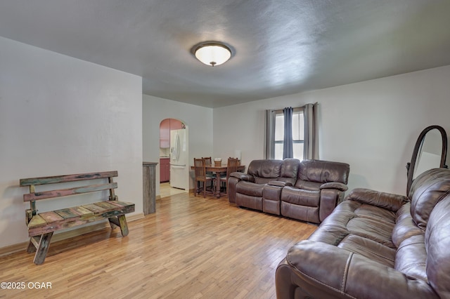 430 N Jackson Ave, Joplin, MO 64801 - living room with arched walkways and light wood-type flooring