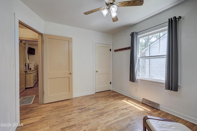430 N Jackson Ave, Joplin, MO 64801 - unfurnished bedroom with light wood-type flooring, baseboards, and a ceiling fan