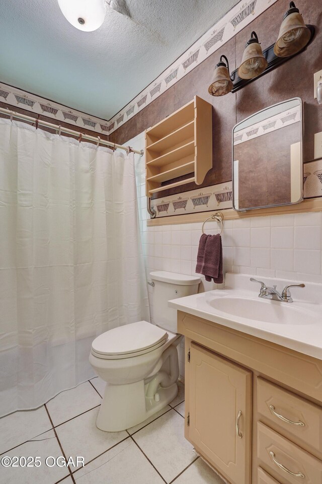 430 N Jackson Ave, Joplin, MO 64801 - full bathroom with toilet, vanity, tile patterned flooring, a textured ceiling, and tile walls